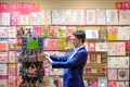 A male customer browsing MotherÃ¢â¬â¢s Day cards in a stationery st